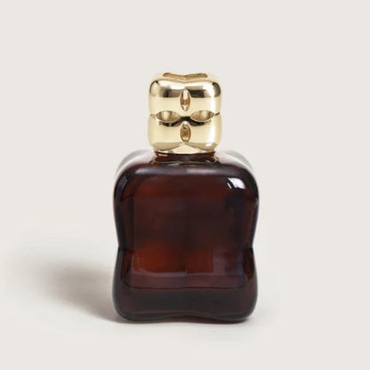 Maison Lampe Berger Cozy collection lamp in color prune, paired with a matching gold diffuser top.