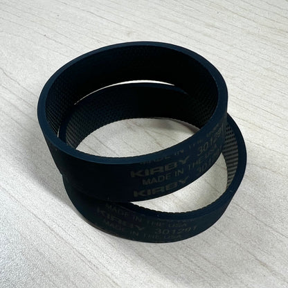 Two Kirby vacuum belts on flat surface.
