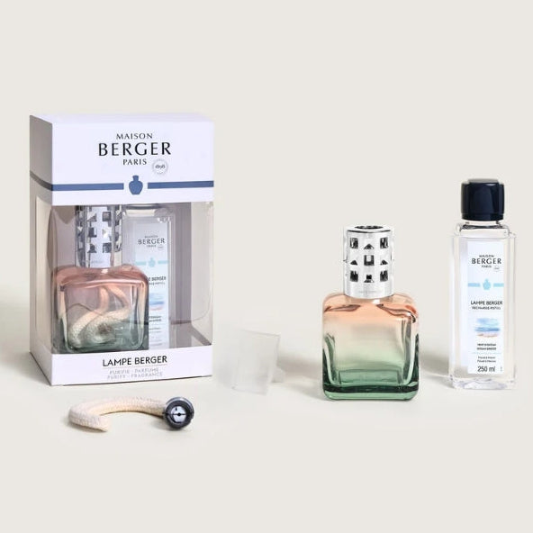 Maison Berger Paris Lampe Berger refill kit including a white branded box, a gradient green and peach bottle, a bottle of fuel, and a burner stone/wick.