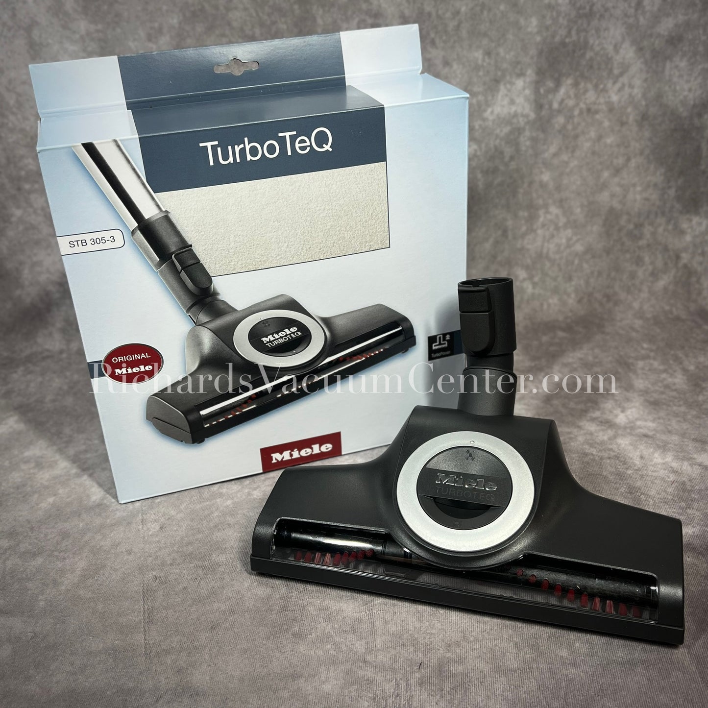Miele TurboTeQ vacuum attachment with packaging on a gray background