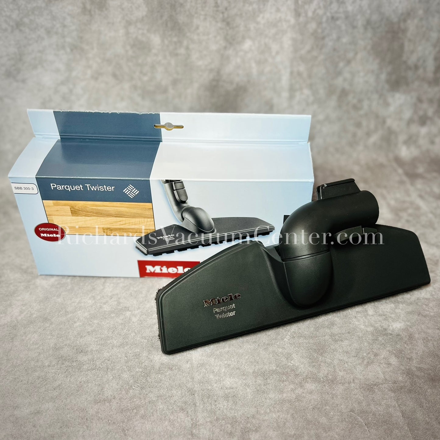 Miele parquet twister with packaging on a gray surface