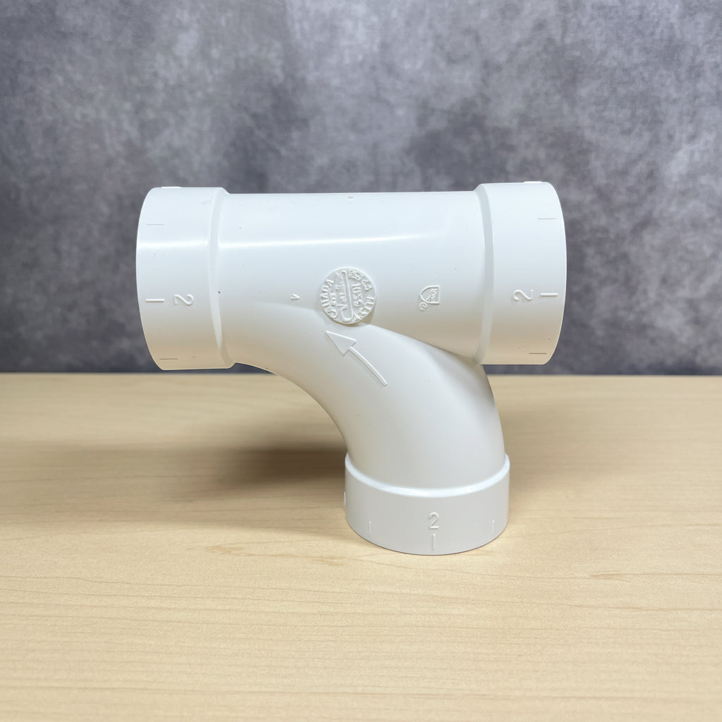 White PVC pipe fitting on for central vacuum pipe systems